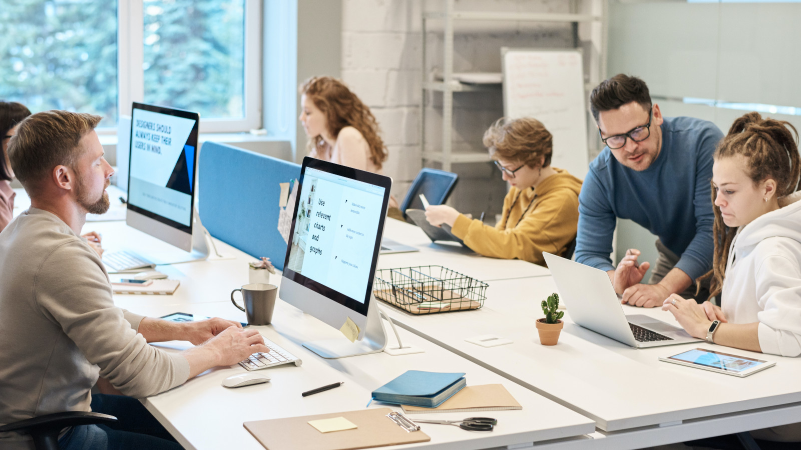 Employees of a company working on desks with computers