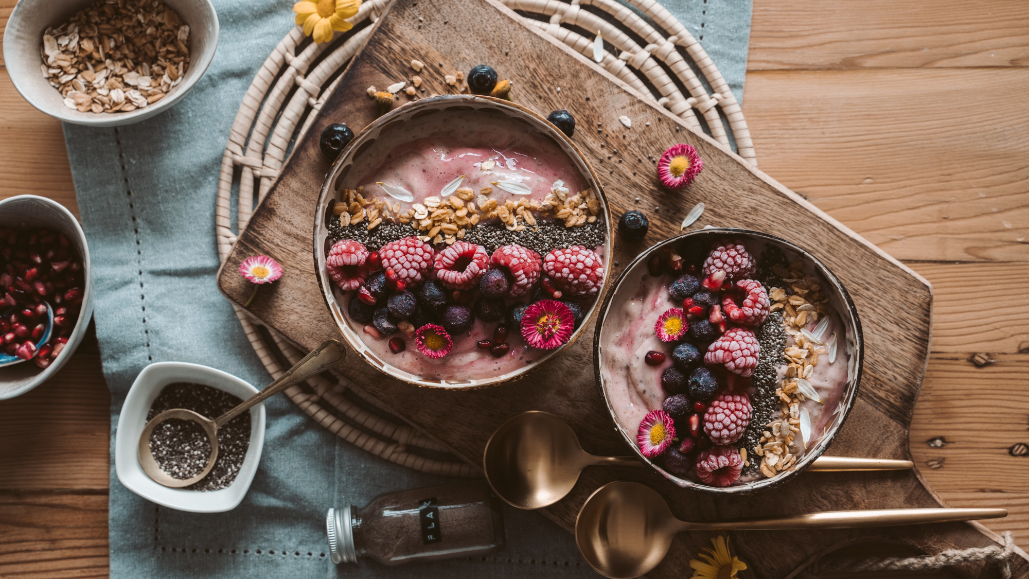 A breakfast table set with cereal with yoghurt and fruit.