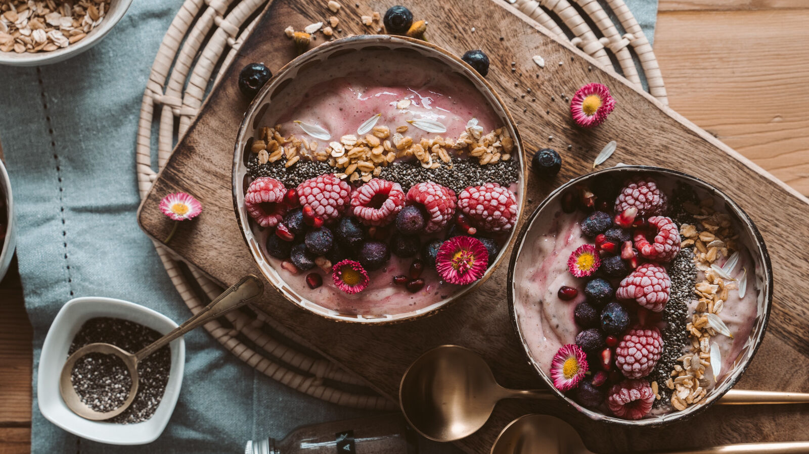 A breakfast table set with cereal with yoghurt and fruit.